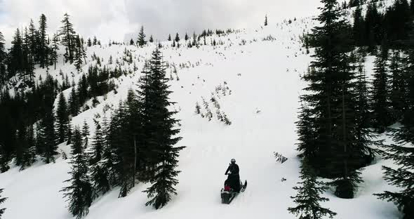 Snowmobiling Up Snowy Hill