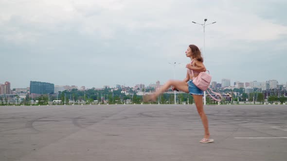 Woman with Perfect Figure Walks in Beautiful Gait and Waves Her Foot Up While Taking Off Her Shoes