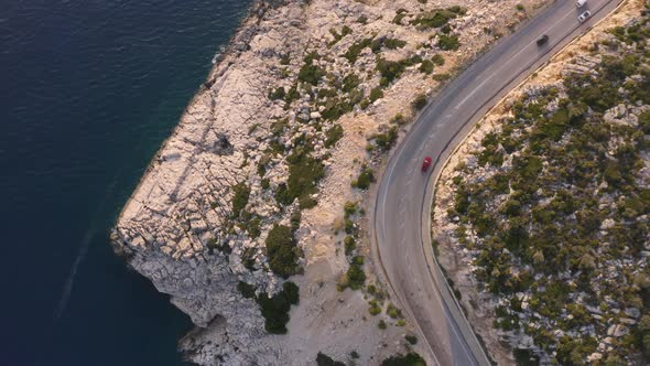 Aerial View of Cars Driving on the Road Along the Coastal Landscape