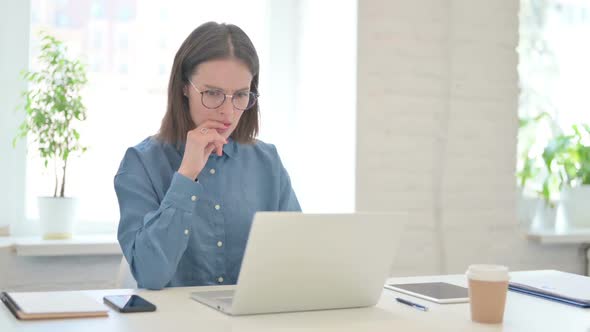 Young Woman Feeling Disappointed while using Laptop