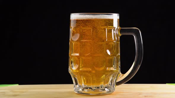 Bubbles of beer in a glass macro. Mug cold craft beer in a glass with water drops close up