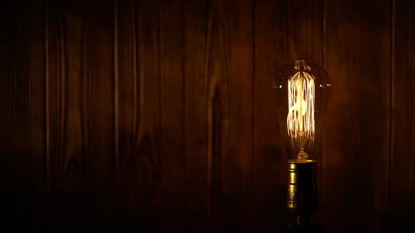 Edison Light Bulb on Wooden Background