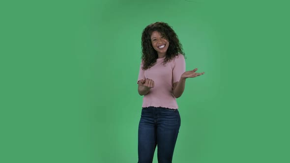 Portrait of Beautiful African American Young Woman Is Looking at Camera with Enthusiastically Waving