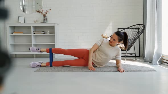 The Girl is Engaged in Fitness at Home at Home