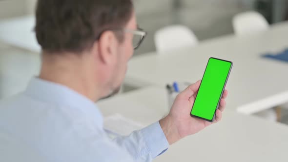 Man Holding Smartphone with Green Chroma Key Screen