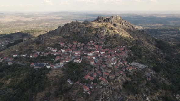 Aerial pullback revealing Stunning remote village and Hilltop castle, Monsanto - Portugal