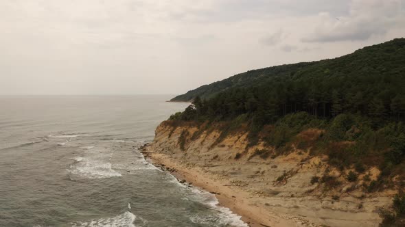 Aerial Drone Top View Over Ocean Black Sea Sand Beach Rocky Mountains Cliffs Dense Forest Bright