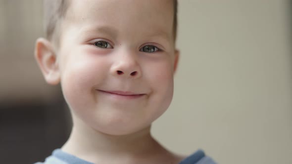 Smiling Face Caucasian Baby Child Kid of 4 Years Shy Looking to Camera Funny