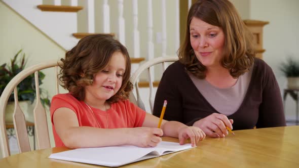 Mother helping daughter with homework