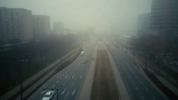 Flight Over Blurred City Street in Fog