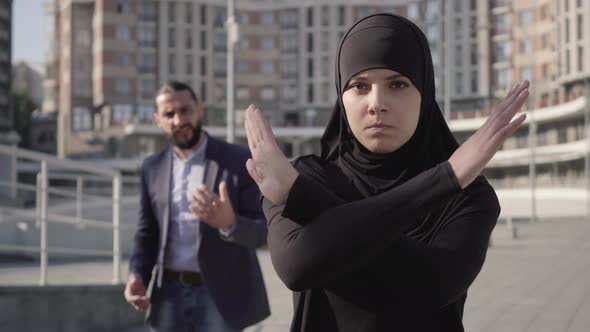 Stressed Confident Muslim Woman Turning From Man Yelling at the Background and Gesturing No By