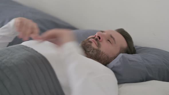 Man Waking Up From Sleep in Bed