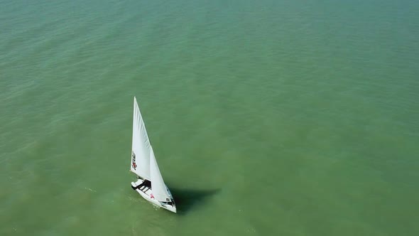 Passing afternoon drone view from a little sailboat near the shore of Zamárdi, Lake Balaton. ( DJi D