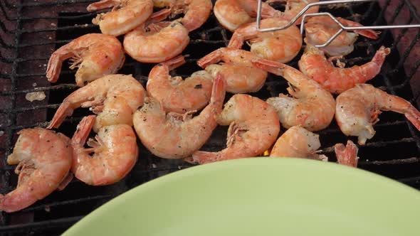 Closeup of the Large King Prawns Taken From the Grill Grid with Kitchen Tongs