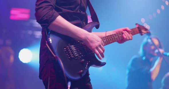 Man is Playing Guitar on Stage