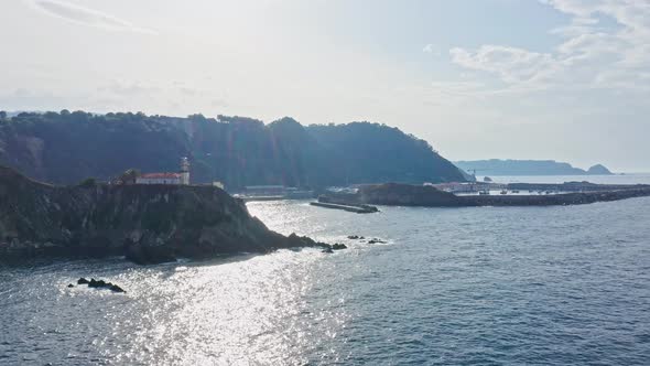 Cudillero Coastline, Lighthouse and Harbor Seascape, Sunlight glare on Water surface, Aerial View