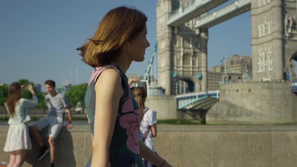 Young woman walking by Tower Bridge