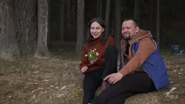 A Couple of Lovers are Sitting in the Forest in a Camping Camp and Talking