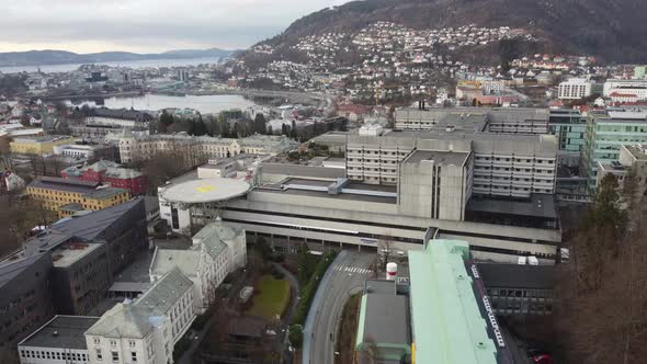 Haukeland hospital with Bergen city in background - Upwarding aerial close to hospital buildings wit