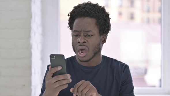 Sad African Man Shocked By Loss on Smartphone