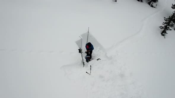 Man Making Shelter in the Snow