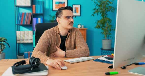 Focused Concentrated Young Businessman Sit at Desk Look at Camera Serious Male Professional Analyst