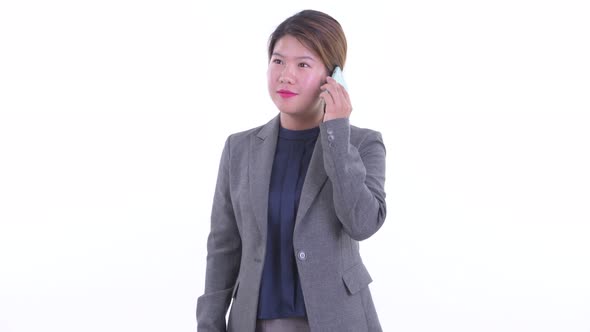 Happy Young Asian Businesswoman Talking on the Phone