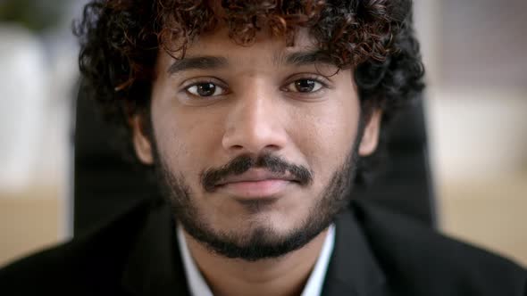 Closeup of a Confident Curlyhaired Indian Business Man Business Owner Company Leader or Sales