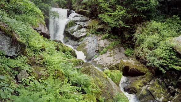 POV Walking Toward Beautiful Waterfall in Forest Wilderness