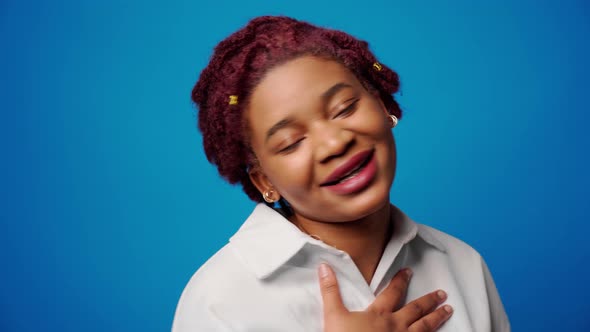 Happy Smiling Young Afro Woman Feeling so Grateful Putting Hand on Her Chest