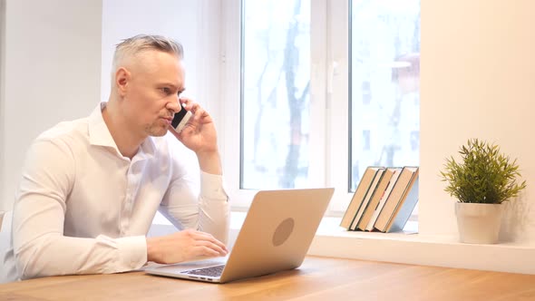 Business Phone Talk  at Work by Middle Age Man