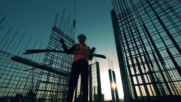 Foreman Checks Reinforcement Mesh on the Site.