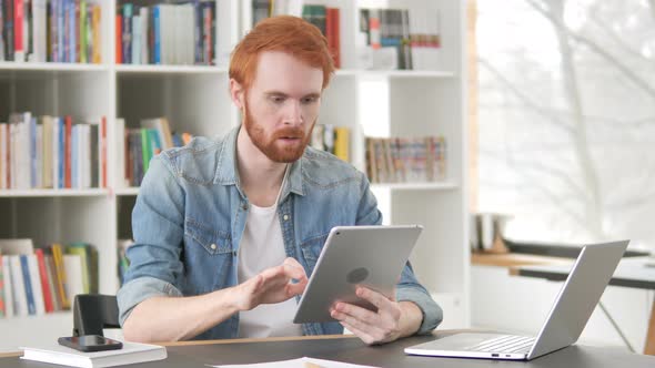 Upset Casual Redhead Man Facing Loss on Tablet