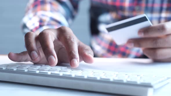 Man Hands Holding Credit Card and Using Keyboard Shopping Online