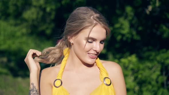 CU, Portrait: Young Beautiful Girl in Lush Yellow Evening Dress Posing Against the Trees, Smiling