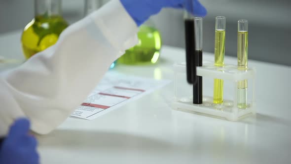 Chemist Marking Tube With Black Substance, Examining Soil Solution, Fertility