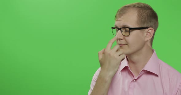 Caucasian Man in Pink Shirt Showing Something. Place for Your Logo or Text