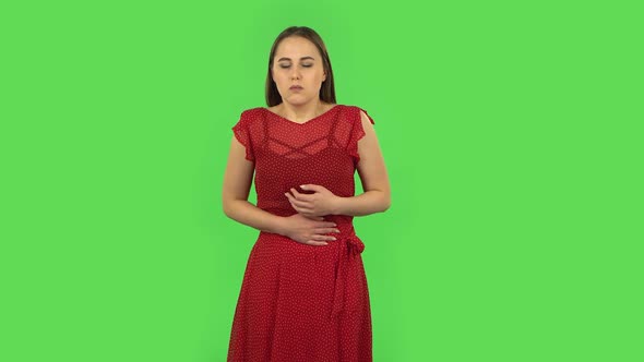 Tender Girl in Red Dress Is Feeling Bad, Her Stomach Hurts, Feeling Nausea. Green Screen