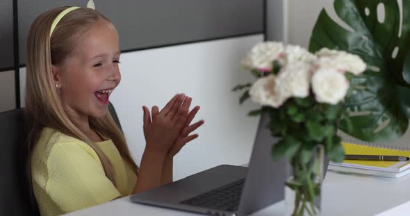 Caucasian Little Girl School Pupil Studying Online From Home Watching Web Class Lesson or Listening