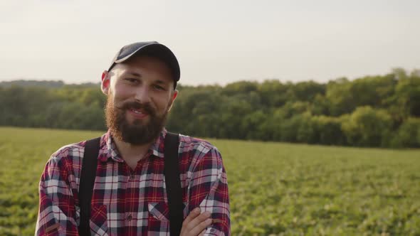 Farmer Slimes and Waves His Head on a Field