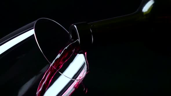 Red Wine Being Poured Into a Glass, Black, Closeup, Slowmotion