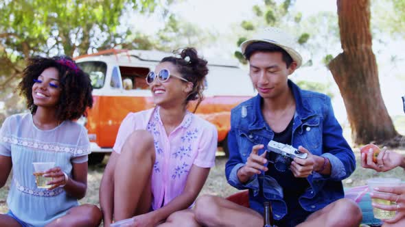 Friends playing guitar and having drinks at music festival 4k