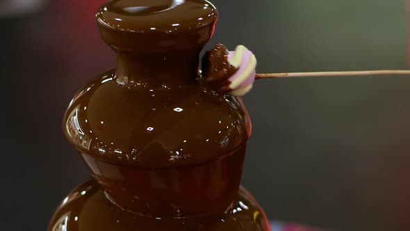 Fountain fondue chocolate placed on a table. Party and celebration by dipped marshmallow