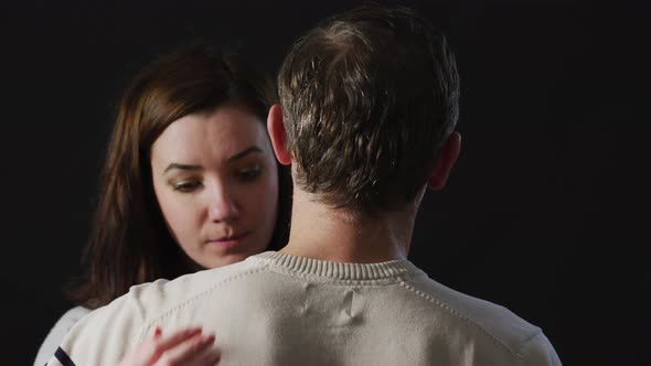 Woman hugging man with sadness