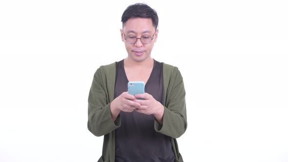 Happy Japanese Man with Eyeglasses Thinking While Using Phone