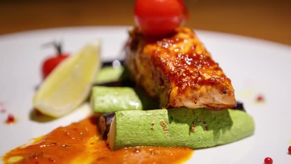 Delicious salmon fillet grilled for lunch and served with vegetables on table