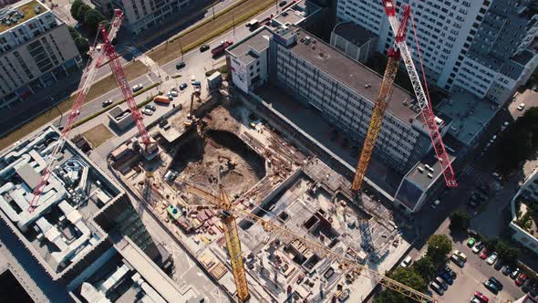 Professional Construction Site Including Several Cranes Working on a Building Complex