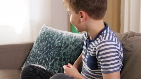 Boy with Popcorn Watching Tv at Home