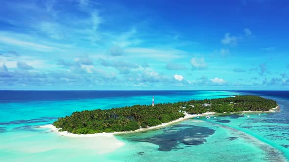 Natural birds eye travel shot of a white sandy paradise beach and blue water background in hi res 4K