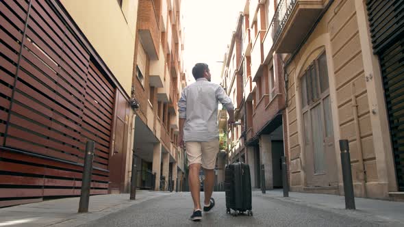 Close Up on Lower or Bottom Part of Business Man Leg Walking Forward with Blue Baggage on the